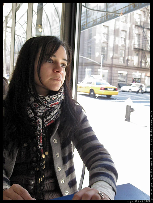 Portrait of a woman by a New York café window