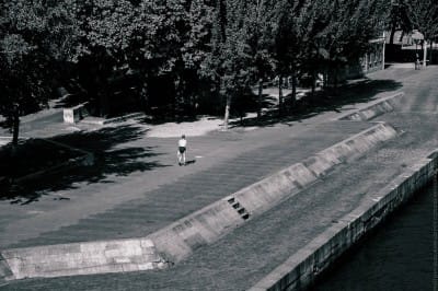 Black & White photo of a nude homeless walking in Paris by the Seine photo by guillaume louyot © onickz artworks